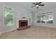 Bright living room with a brick fireplace, large windows, and plenty of natural light at 2995 Aspen Ridge Ct, Snellville, GA 30078