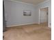 Spacious living room with neutral carpet and paint, featuring a view into an adjacent room at 2995 Aspen Ridge Ct, Snellville, GA 30078