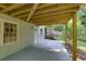 Back patio featuring concrete flooring and ceiling, offering a covered area for outdoor enjoyment, with natural views at 2995 Aspen Ridge Ct, Snellville, GA 30078