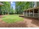 Backyard with a screened porch and ample space for outdoor enjoyment amid mature trees and a lush lawn at 4504 Reva Ne Way, Marietta, GA 30066