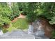 Aerial view of large, fenced backyard with mature trees and a storage shed at 4504 Reva Ne Way, Marietta, GA 30066