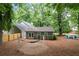 Cozy backyard featuring a detached structure, wood fence, hammock, fire pit, and lush landscaping at 4504 Reva Ne Way, Marietta, GA 30066