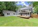 Spacious backyard featuring a screened porch, wooden deck, and lush landscaping, ideal for relaxation and entertainment at 4504 Reva Ne Way, Marietta, GA 30066