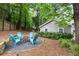 Backyard area with comfortable seating surrounding a fire pit for outdoor gatherings in a private, wooded setting at 4504 Reva Ne Way, Marietta, GA 30066