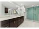 Elegant bathroom featuring a double vanity with quartz countertops and an enclosed glass walk-in shower with blue tiling at 4504 Reva Ne Way, Marietta, GA 30066