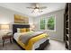 Cozy bedroom with a bed, end table, and natural light coming through the windows overlooking the green landscape at 4504 Reva Ne Way, Marietta, GA 30066