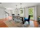 Open dining room with a stylish table and chairs next to windows and hardwood floors at 4504 Reva Ne Way, Marietta, GA 30066