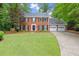 Charming two-story brick home with well-manicured lawn and a three-car garage at 4504 Reva Ne Way, Marietta, GA 30066