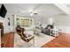 Cozy living room featuring hardwood floors, fireplace, and natural light at 4504 Reva Ne Way, Marietta, GA 30066