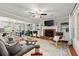 Inviting living room featuring a brick fireplace, ceiling fan, and built-in shelving at 4504 Reva Ne Way, Marietta, GA 30066