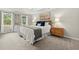 Tranquil main bedroom featuring tray ceilings, carpet floors, and matching nightstands illuminated by bedside lamps at 4504 Reva Ne Way, Marietta, GA 30066