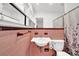 Neat bathroom featuring a pedestal sink, a floral shower curtain, and pink tiling at 1981 Bramblewood Ne Dr, Brookhaven, GA 30329