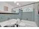Charming bathroom with teal tiling, a shower-tub combo and updated fixtures at 1981 Bramblewood Ne Dr, Brookhaven, GA 30329