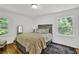 Cozy bedroom with hardwood floors, decorative rug and a large headboard at 1981 Bramblewood Ne Dr, Brookhaven, GA 30329