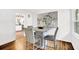 Dining room with modern table set, hardwood floors, and an open view into the kitchen at 1981 Bramblewood Ne Dr, Brookhaven, GA 30329