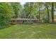 Well-maintained single story brick home with a lush front lawn and surrounded by mature trees at 1981 Bramblewood Ne Dr, Brookhaven, GA 30329