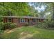 Charming single story brick home with well-manicured lawn and mature trees offering shade and curb appeal at 1981 Bramblewood Ne Dr, Brookhaven, GA 30329