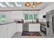 Bright kitchen with stainless appliances, white cabinets, and stylish modern lighting at 1981 Bramblewood Ne Dr, Brookhaven, GA 30329