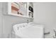 White laundry room equipped with a washing machine, dryer and ample storage at 1981 Bramblewood Ne Dr, Brookhaven, GA 30329