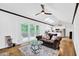 Living room with vaulted ceilings, hardwood floors, and a sliding glass door leading to a deck at 1981 Bramblewood Ne Dr, Brookhaven, GA 30329