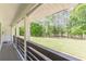 Inviting back porch showcasing serene views of the expansive green lawn and mature trees at 218 Ward Rd, Ellenwood, GA 30294