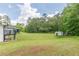 Large grassy yard with detached structures at 218 Ward Rd, Ellenwood, GA 30294