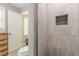 Bathroom featuring a tiled walk-in shower with built-in storage and modern fixtures at 218 Ward Rd, Ellenwood, GA 30294