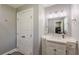 Clean bathroom with modern vanity, decorative lighting, and well-maintained tile floors at 218 Ward Rd, Ellenwood, GA 30294