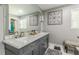 Bathroom with double sinks, marble countertop, modern fixtures, and elegant wall decor at 218 Ward Rd, Ellenwood, GA 30294
