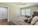 Cozy bedroom with neutral tones, ceiling fan, double door closet, and a window with natural light at 218 Ward Rd, Ellenwood, GA 30294