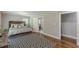Stylishly decorated bedroom with hardwood floors, a striking black-and-white rug, and a cozy, inviting ambiance at 218 Ward Rd, Ellenwood, GA 30294