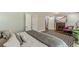 This bedroom includes a fireplace, television, decorative rug, beautiful wood floors, and access to the bathroom at 218 Ward Rd, Ellenwood, GA 30294