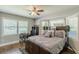 Comfortable bedroom with a ceiling fan, carpet, large windows and closet storage at 218 Ward Rd, Ellenwood, GA 30294