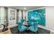 The stylish dining room features elegant decor, including a glass table, plush chairs, and vibrant artwork at 218 Ward Rd, Ellenwood, GA 30294