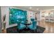 Stylish dining room adjacent to the kitchen featuring a modern glass table, plush chairs, and unique artwork at 218 Ward Rd, Ellenwood, GA 30294