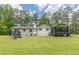 Back exterior of home with deck and screened porch at 218 Ward Rd, Ellenwood, GA 30294