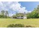 Bright two-story home featuring a well-manicured lawn, complementing trees, and freshly painted exterior at 218 Ward Rd, Ellenwood, GA 30294