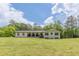 Well-maintained exterior of a bright home, featuring a lush front lawn and manicured landscaping at 218 Ward Rd, Ellenwood, GA 30294