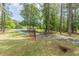 Scenic front yard showcasing a gated driveway entrance that enhances the property's security and aesthetic at 218 Ward Rd, Ellenwood, GA 30294