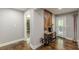 Open hallway boasts hardwood floors, modern decor, and a convenient bar area with wine storage at 218 Ward Rd, Ellenwood, GA 30294