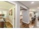 Hallway view showcasing hardwood floors and a seamless transition to the kitchen, promoting a bright and airy atmosphere at 218 Ward Rd, Ellenwood, GA 30294
