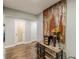 Hallway with hardwood floors, glass storage, and an eye-catching abstract painting on the wall at 218 Ward Rd, Ellenwood, GA 30294