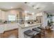Bright kitchen features granite countertops, stainless steel appliances, an island with seating, and modern pendant lights at 218 Ward Rd, Ellenwood, GA 30294