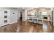 Spacious living area with hardwood floors leading to kitchen with island and barstool seating at 218 Ward Rd, Ellenwood, GA 30294