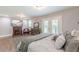 Comfortable main bedroom with a fireplace, decorative art, a ceiling fan, and access to an outdoor balcony at 218 Ward Rd, Ellenwood, GA 30294