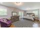 Bright and stylish main bedroom featuring a ceiling fan and French doors leading to an outdoor balcony at 218 Ward Rd, Ellenwood, GA 30294
