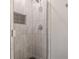 Modern shower with tile surround, recessed niche, glass doors, and sleek fixtures at 218 Ward Rd, Ellenwood, GA 30294