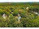 Aerial neighborhood view featuring mature trees and a lake in the distance at 2912 Vinings Forest Se Way, Atlanta, GA 30339
