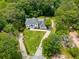 Estate aerial view featuring a lush manicured lawn, mature trees, and a long driveway at 2912 Vinings Forest Se Way, Atlanta, GA 30339