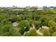 Aerial neighborhood view featuring mature trees and downtown in the distance at 2912 Vinings Forest Se Way, Atlanta, GA 30339